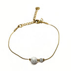 Bracelet doré en acier inoxydable avec deux perles de howlite blanche, bijou minimaliste et raffiné Clyvia Bijoux.