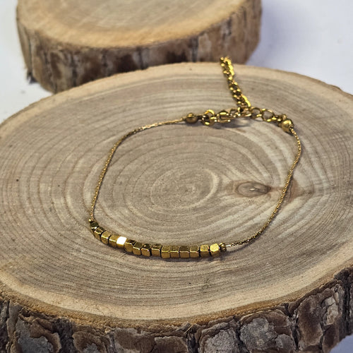 Bracelet fin en acier inoxydable doré et petites perles sur support bois - Clyvia Bijoux 