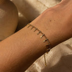 Bracelet fin Orelk en acier inoxydable doré porté au poignet