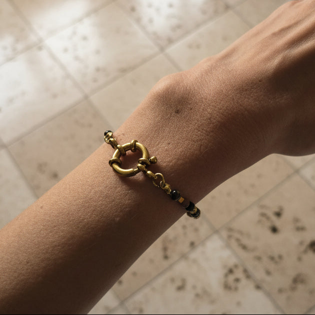 Bracelet en acier inoxydable doré avec rhodonite et breloque lune, porté, Clyvia Bijoux