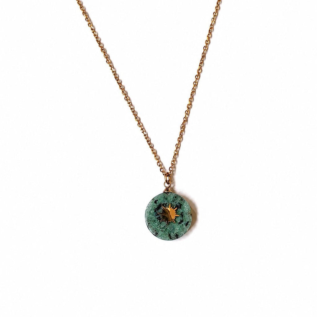 Collier long doré avec pendentif soleil en jaspe turquoise africaine sur fond blanc