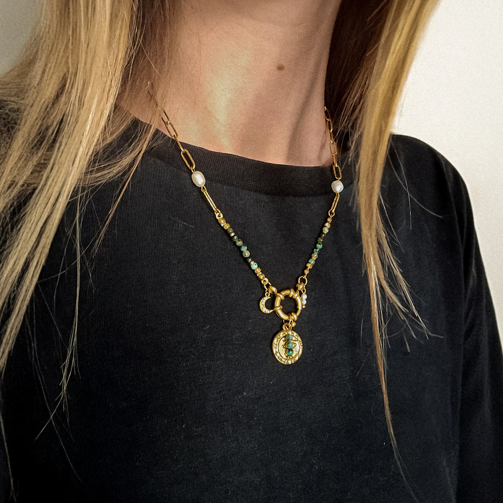 Collier doré avec jaspe turquoise africain, perles blanches et médaille œil, porté, Clyvia Bijoux