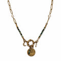 Collier femme en turquoise africaine avec chaîne dorée, perles blanches, pendentif oeil et breloque lune sur fond blanc